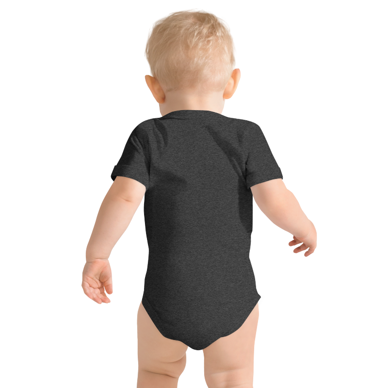 Baby wearing a dark, grey heather onesie pictured from behind, on plain background by Less Hustle, More Joy.