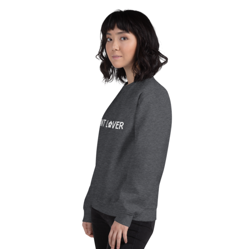 A person facing left wearing a dark grey heather sweatshirt from Less Hustle, More Joy with the words 'PLANT LOVER' printed on the front in white text.