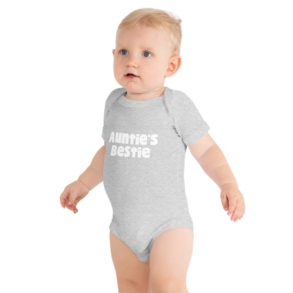 Baby wearing an athletic heather onesie with white 'Auntie's Bestie' text, on plain background, by Less Hustle, More Joy.