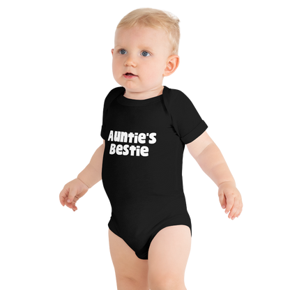 Baby wearing a black onesie with 'Auntie's Bestie' text, on plain background, by Less Hustle, More Joy.
