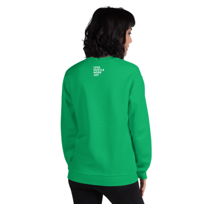 A person shown from the back wearing an Irish green sweatshirt from Less Hustle, More Joy with the words 'PLANT LOVER' printed on the front in white text and the words Less Hustle More Joy printed on the back in small white text.