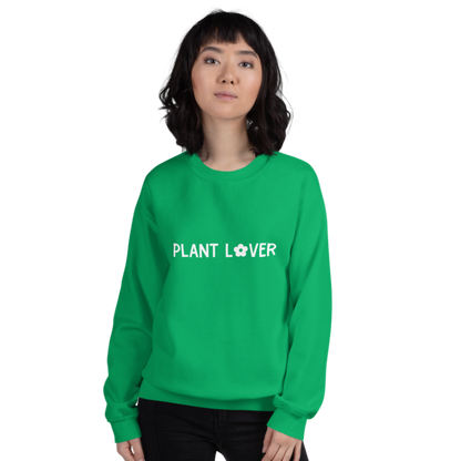 A person wearing an Irish green sweatshirt from Less Hustle, More Joy with the words 'PLANT LOVER' printed on the front in white text.