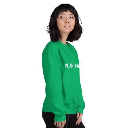 A person shown facing right, wearing an Irish green sweatshirt from Less Hustle, More Joy with the words 'PLANT LOVER' printed on the front in white text.