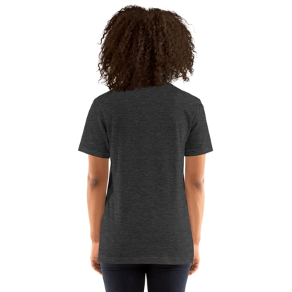 A person shown from the back wearing a dark grey heather t-shirt by Less Hustle, More Joy, with the words 'PLANT LOVER' printed on the front in white text.