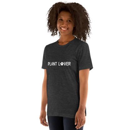 A person shown from the side wearing a dark grey heather t-shirt by Less Hustle, More Joy, with the words 'PLANT LOVER' printed on the front in white text.