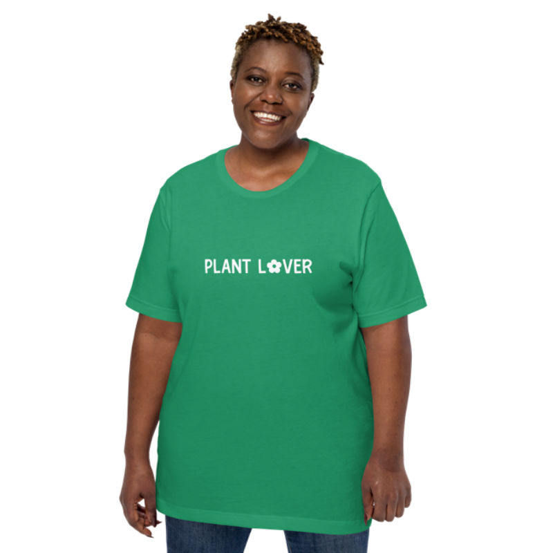 A person wearing a kelly green heather t-shirt by Less Hustle, More Joy, with the words 'PLANT LOVER' printed on the front in white text.