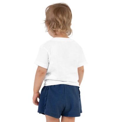 Back view of a white, short-sleeved toddler tee by Less Hustle, More Joy. The front features the word 'Strong' printed in punk rock pink text.