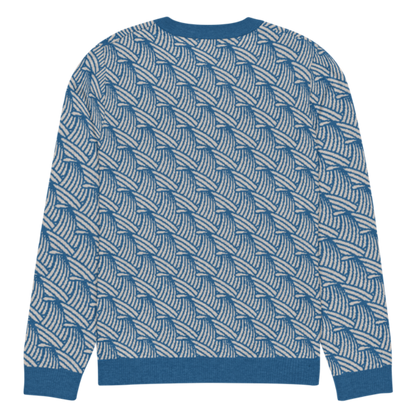 A lay-flat image of the back of a L size crew-neck knitted sweater with a wave pattern in blue and sand colours by Less Hustle, More Joy.