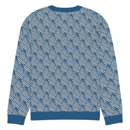 A lay-flat image of the back of an XL size crew-neck knitted sweater with a wave pattern in blue and sand colours by Less Hustle, More Joy.